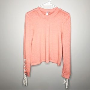 Alternative coral sweater with lace up sleeves